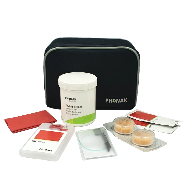 The C&C Kit 2 ITE & BTE comes with a black zippered pouch, white drying beaker, two drying capsules, cleaning cloths, cleaning spray with brush, and wipes—all neatly arranged on a white surface.