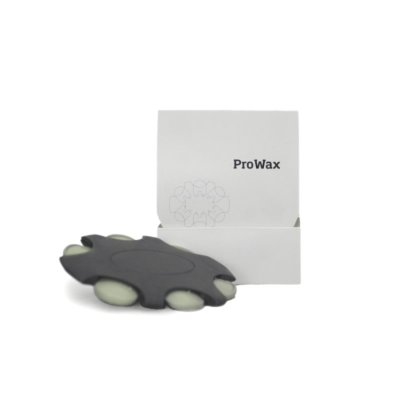 A black, leaf-shaped item with white circular pads is displayed in front of a box labeled "Bernafon ProWax.