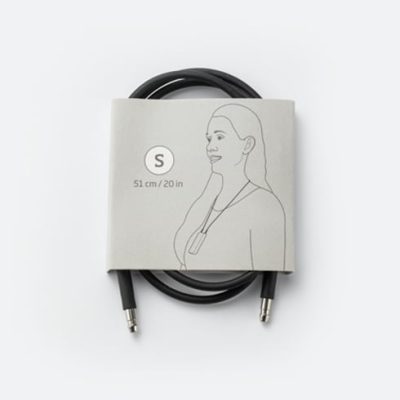 A coiled black Neck Loop for SoundGate with silver connectors is packaged in a grey paper band showing a line drawing of a person wearing it. The label reads S, 51 cm / 20 in.