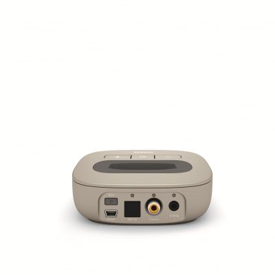 A beige rectangular Phonak TV-Link II Base, shown from the back, features labeled ports—Pair, Optical, Coaxial, Analog—a power button, and the brand name on top.