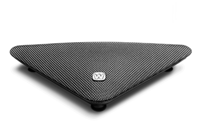 The Widex TV Play is a black, triangular, textured footrest with rounded corners and a central “W” logo, supported by three small spherical feet on a white background.