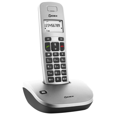 A Widex Phone-Dex cordless landline phone sits upright in its charging base, displaying numbers on its small screen. It features a keypad, call control buttons, and the curved base shows the Widex logo.